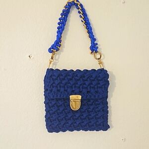 Beautiful royal blue crocheted purse with gold clase.Attract a lot of attention.